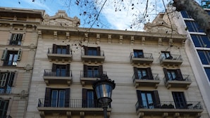 A multi-story building with ornate architectural details, including decorative moldings and balconies. - BCN Paseo de Gracia Rocamora Apartments (Barcelona)