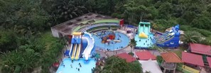 An aerial view of a water park with multiple slides and pools. - Homesweet Muslim Homestay (Jasin)