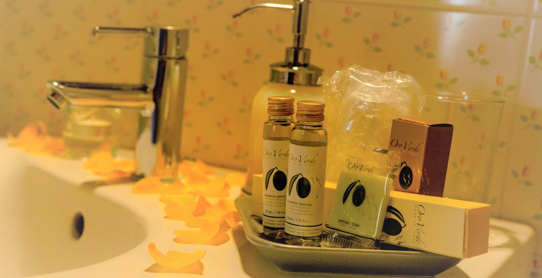 A bathroom sink with toiletries and a soap dispenser.