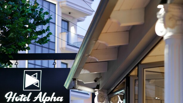 A hotel exterior with a sign reading "Hotel Alpha Bar Restaurant." - Hotel Alpha (Sarandë)