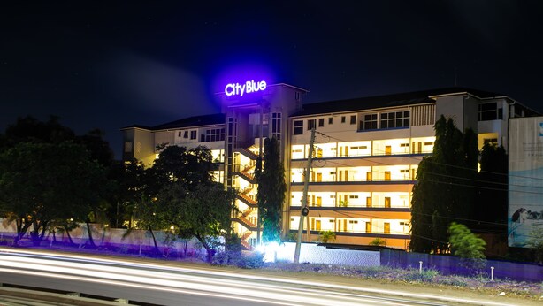 A multi-story hotel with a prominent 'CityBlue' sign, featuring balconies and a central staircase. - CityBlue Creekside Hotel & Suites, Mombasa (Mombasa)