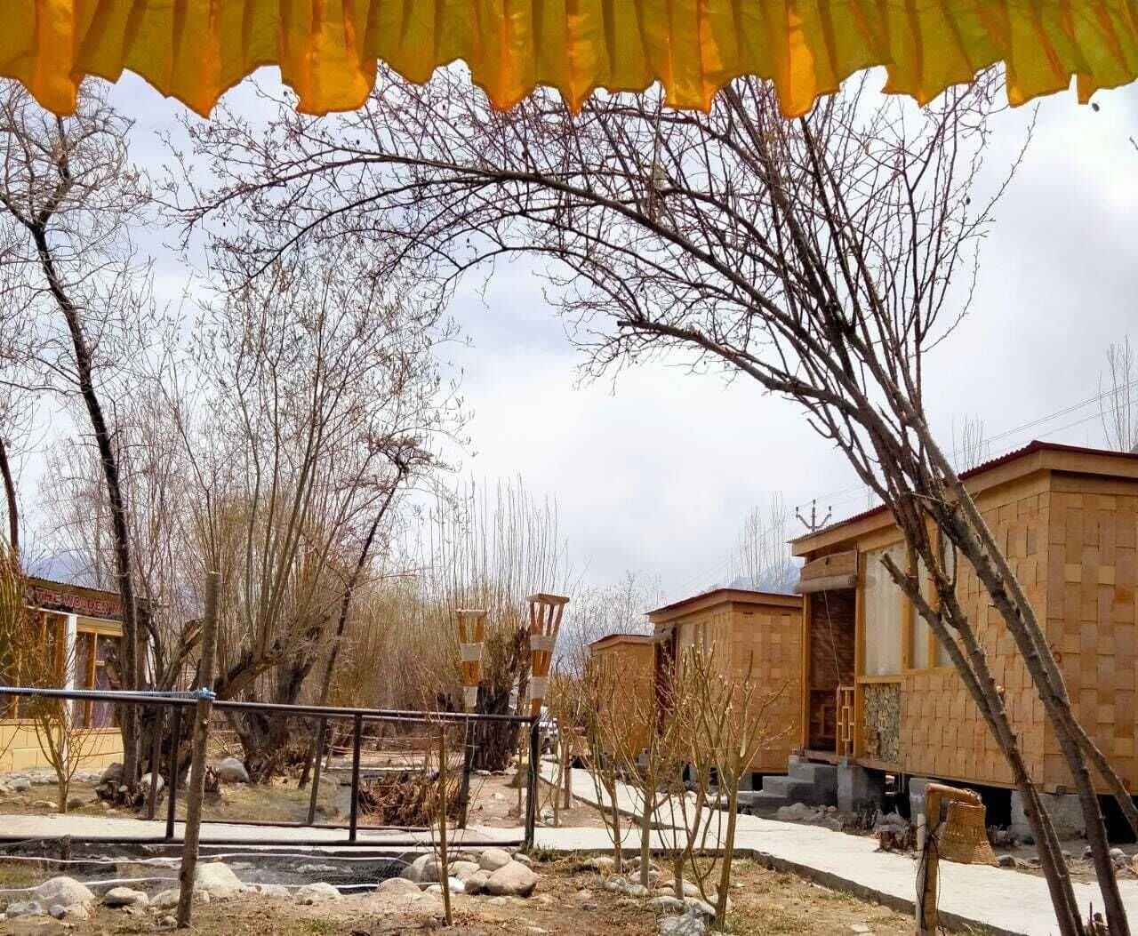 A row of simple, single-story buildings with a flat roof and a small porch area.