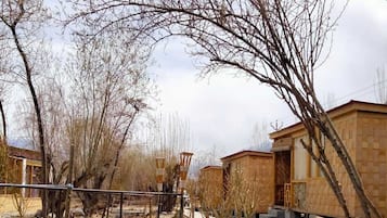 A row of simple, single-story buildings with a flat roof and a small porch area.