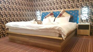 A bed with a wooden frame and a headboard with a geometric pattern.