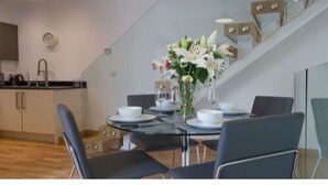A modern kitchen with a dining area. - Tailored Stays  -  Executive Town House (Cambridge)