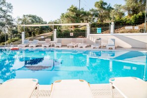 Outdoor pool, open 9 AM to 8 PM, pool umbrellas, pool loungers