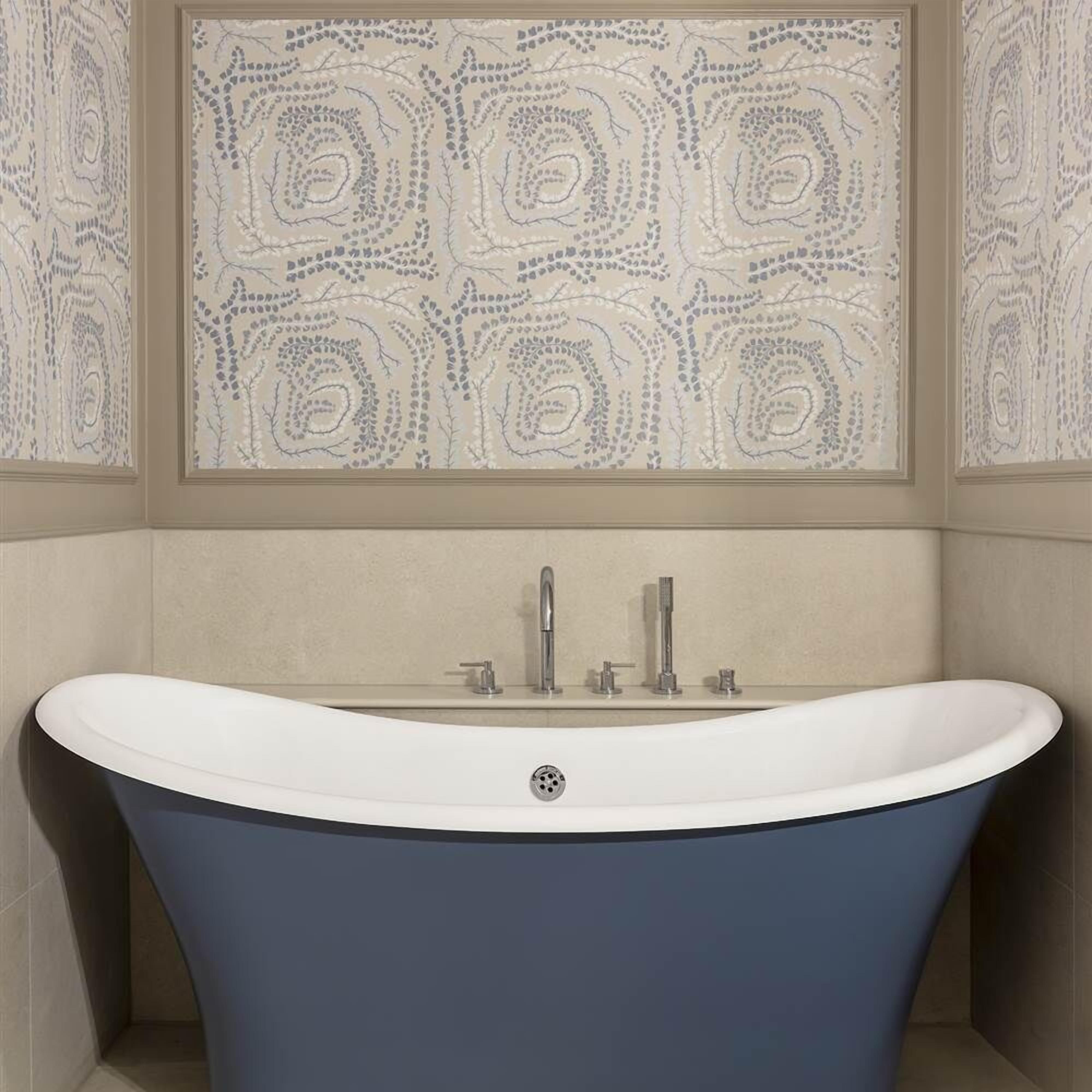 A modern bathroom with a freestanding bathtub, a large mirror, and patterned wall tiles.