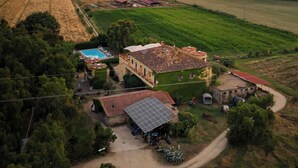 An aerial view of a rural area with fields, a small building with a tiled roof, and a clear sky. - Agriturismo La Petrosa (Ceraso)