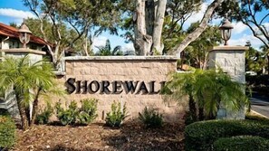 Un letrero de piedra con el nombre 'Shorewall', rodeado de follaje y árboles.