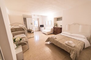 A hotel room with a bed, a chair, a desk, a mirror, and a wardrobe. - Academia Resort (Bergamo)