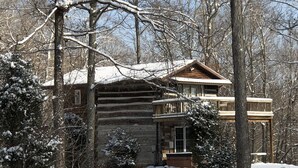 A log cabin with a wooden deck and a snow-covered path leading to the entrance. - Rustic Log Cabin next to the Hoosier National Forest in the Ohio River Valley (Derby)