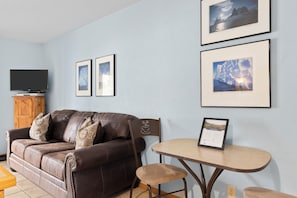 Relax in this inviting living area with a comfortable sofa, coffee table, and flat-screen TV.