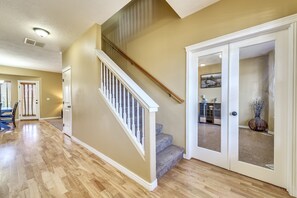 Entryway. French doors lead to a private office . Stairwell leads to bedrooms.