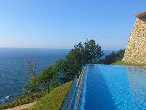 Seasonal outdoor pool, an infinity pool, pool umbrellas, pool loungers - Agroturismo Itxaspe (Orio)