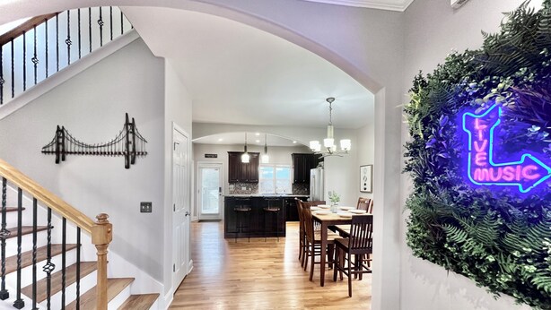 A modern interior with a staircase, a kitchen, and a dining area. - Enjoy a spacious private residence loaded with amenities. Minutes to everything! (Nashville)