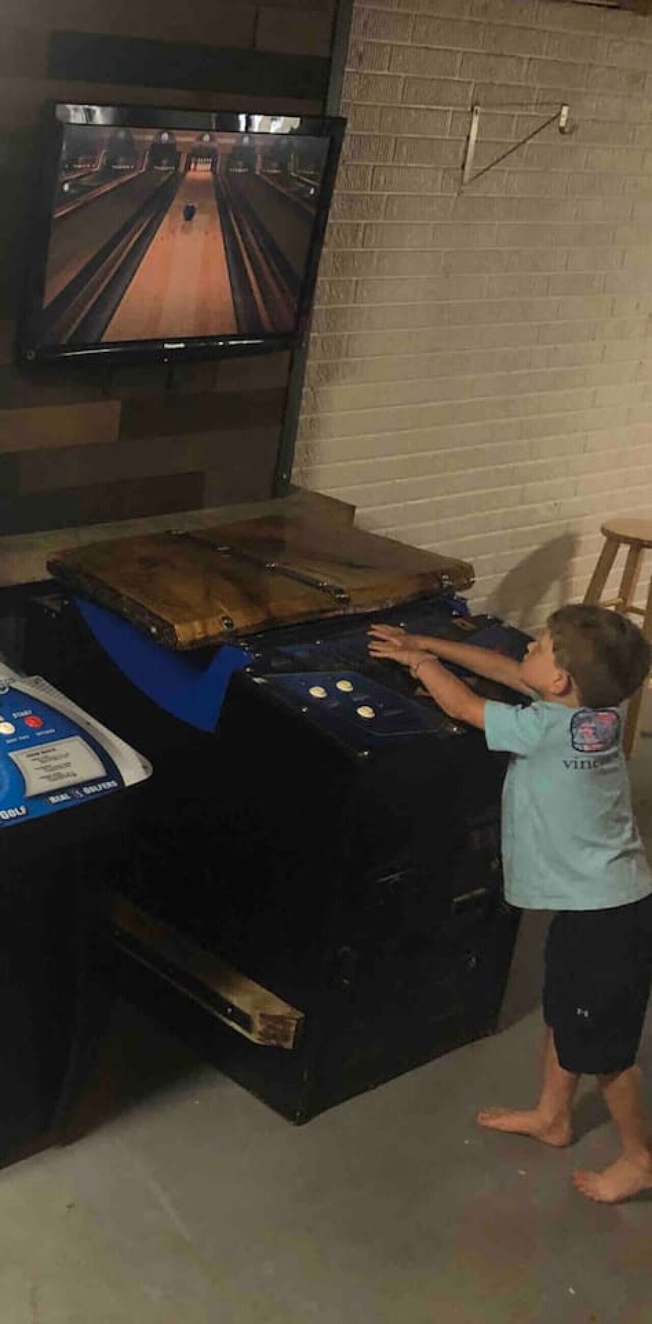 A child playing a bowling game.