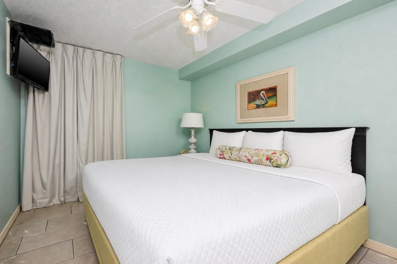 Relax in the serene bedroom suite featuring a king bed, soft linens, and a flat-screen TV for your entertainment