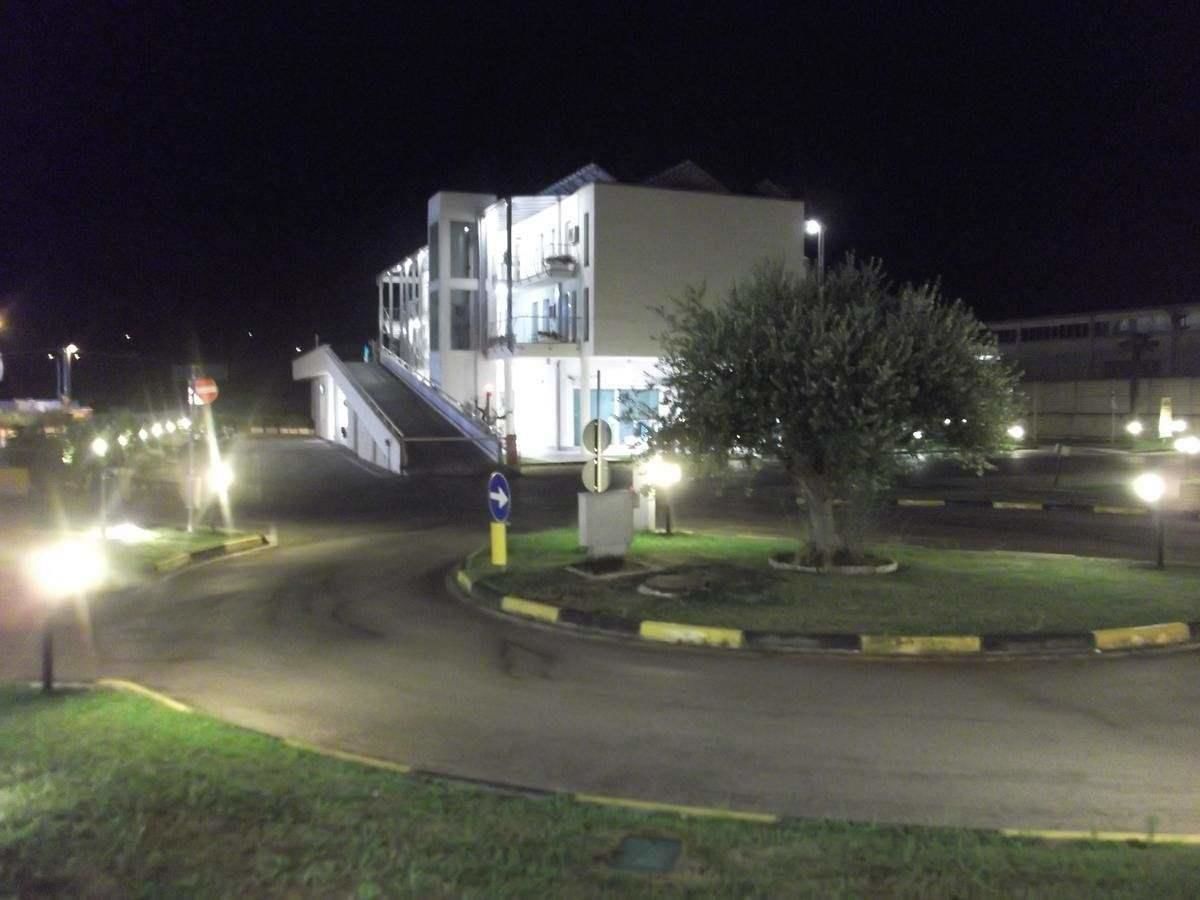 A building with a modern design, featuring a central staircase and a circular driveway.
