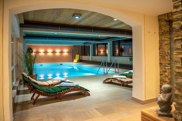 Indoor pool, open 8:00 AM to 8:30 PM, pool umbrellas, pool loungers