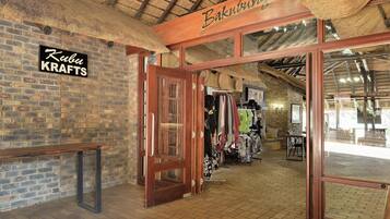 A rustic interior with exposed brick walls, wooden beams, and a sign reading "Baku KRAFTS".
