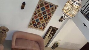 A living room with a sofa, a coffee table, and a patterned rug. - Casa San Miguel 4479 (Mexico City)