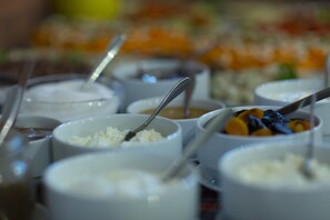 A buffet with various food items and utensils. - Loft Hotel (Borjomi)