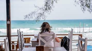 On the beach, white sand, sun loungers, beach umbrellas