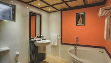 Deep soaking tub, rainfall showerhead, eco-friendly toiletries
