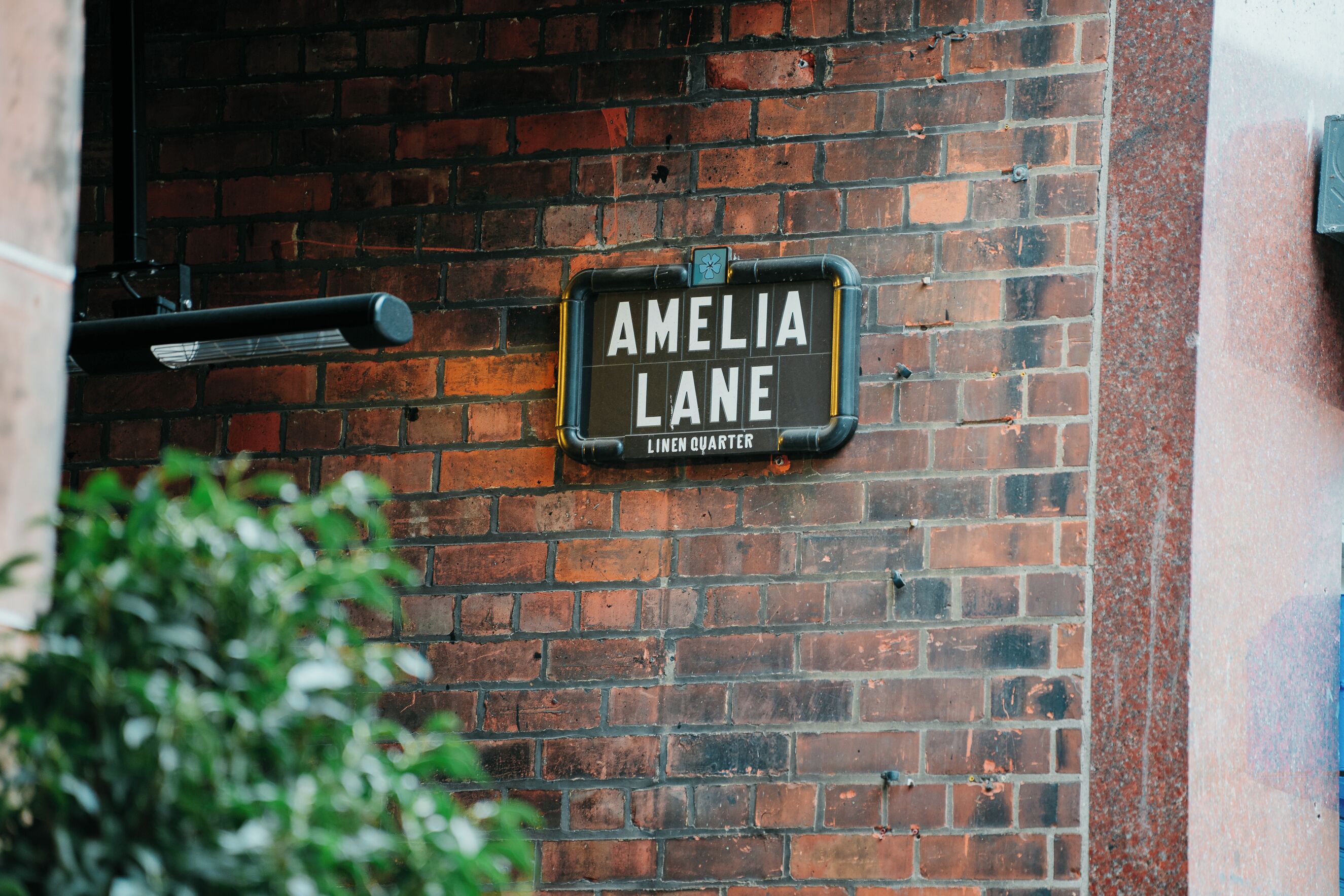 Un muro de ladrillo con un cartel que dice 'Amelia Lane Linen Quarter'.