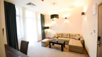 Deluxe Apartment | Living area | Flat-screen TV