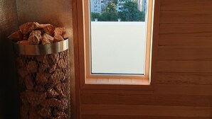 A room with a window overlooking a cityscape, a metal trash bin, and wooden walls. - Days Inn & Suites by Wyndham La Plata (La Plata)