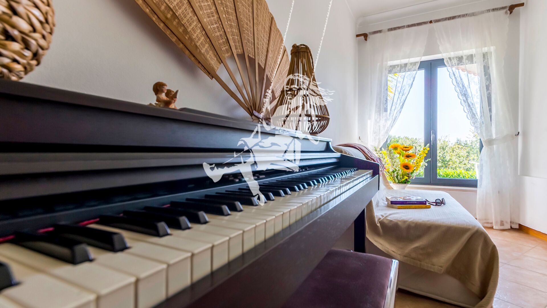 A piano in a room with a view of greenery outside.