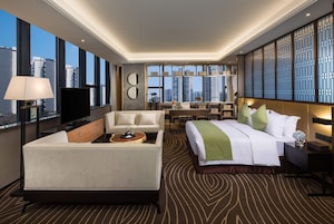 Suite, 1 King Bed, Smoking (Ramada Suite) | Minibar, in-room safe, laptop workspace, soundproofing