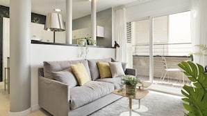 A modern living room with a grey sofa, a coffee table, and a large window with blinds. - Amazing skyline with amazing views (Barcelona)