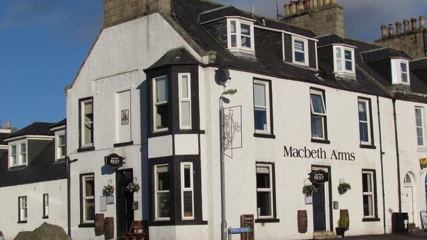 A white building with black trim and the name "Macebeth Arms" on the facade. - Macbeth Arms (Banchory)
