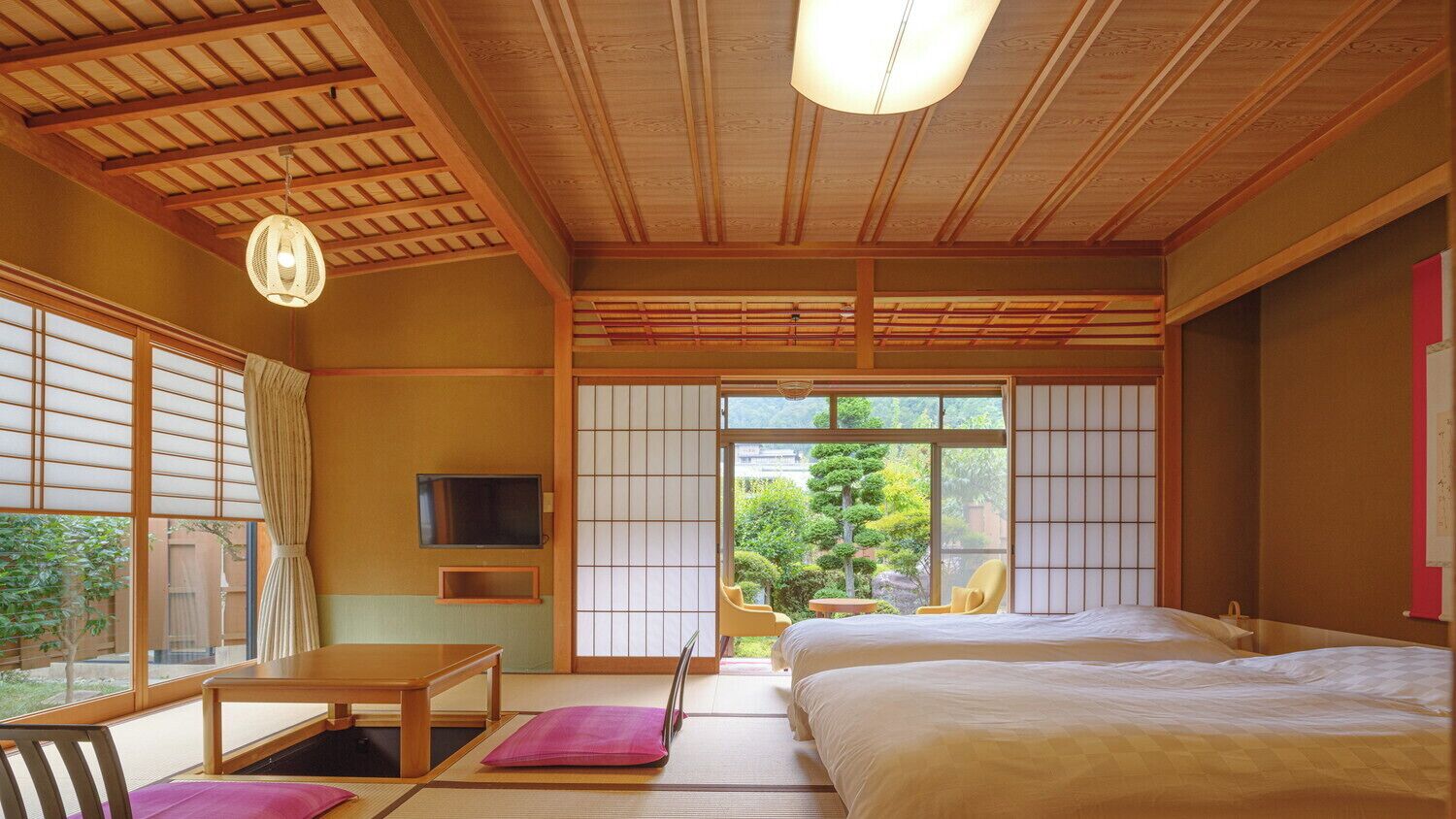 A traditional Japanese-style room with tatami flooring, a bed, a TV, and a view of greenery outside.