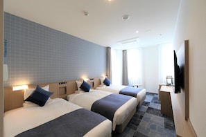 A hotel room with three beds, a desk, a television, and a large window. - Okayama Business Hotel Annex (Okayama)