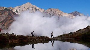 A mountain landscape with a reflective lake, two people walking, and a clear sky. - Hakuba Happo Onsen Hakuba Marukin Ryokan (Hakuba)
