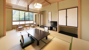 A traditional Japanese-style room with tatami flooring, a low table, and sliding doors. - Hotel Achigawa (Achi)