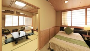 A traditional Japanese-style room with tatami flooring, a low bed with a green pillow, a small table with a vase, and sliding doors. - Hotel Achigawa (Achi)