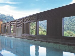 A pool with a view of a forested mountain range.