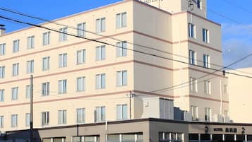 A multi-story hotel with a flat facade, numerous windows, and a sign indicating it is a hotel.