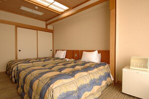 A hotel room with two beds, a wooden ceiling, and a white nightstand.