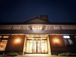 Un edificio de estilo arquitectónico japonés tradicional, con una entrada destacada que incluye puertas correderas y un cartel en la parte superior.