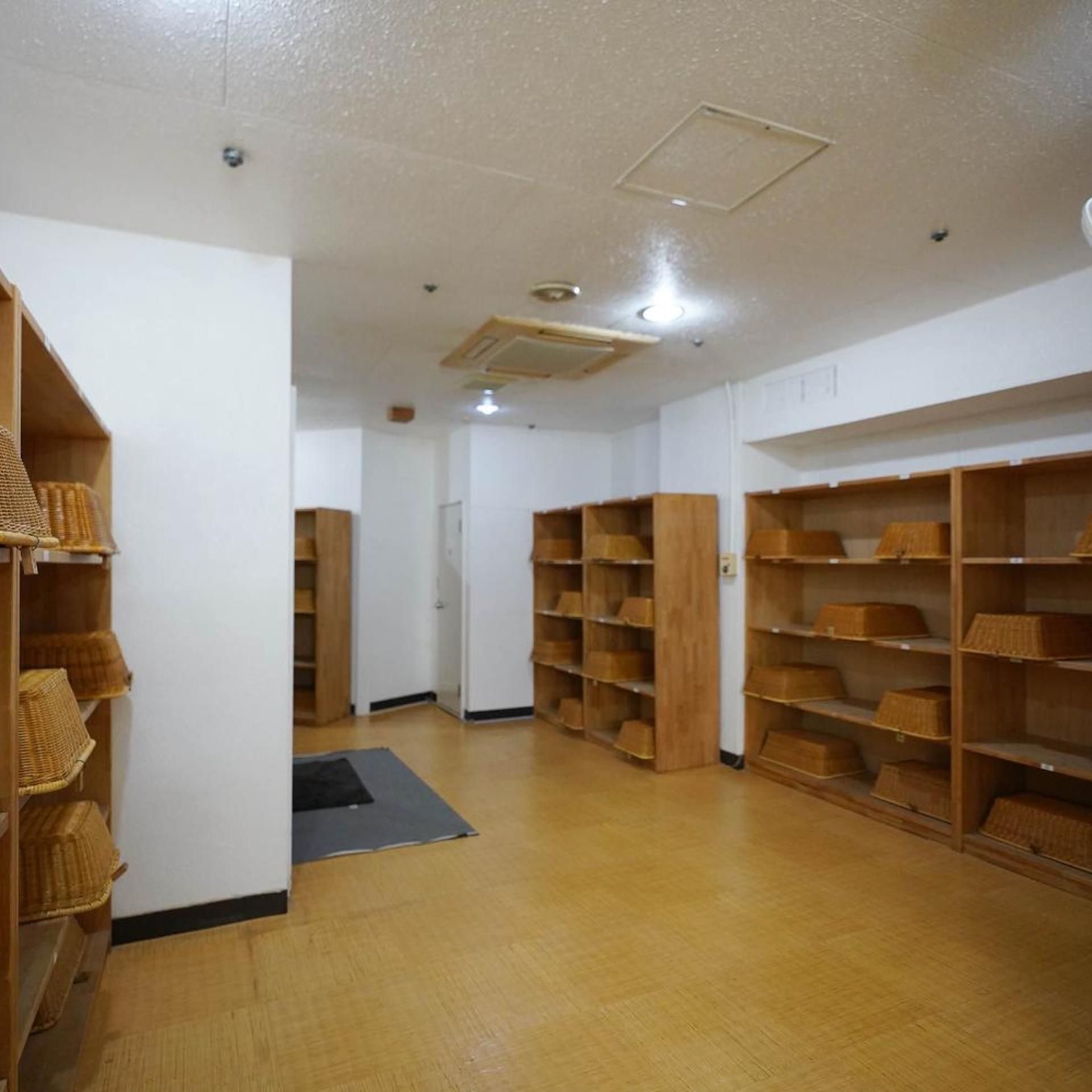 A room with wooden shelving units and a central door.
