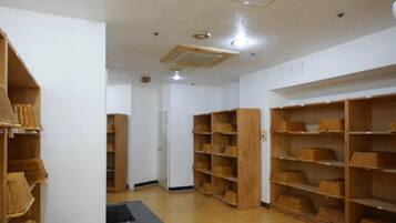 A room with wooden shelving units and a central door.