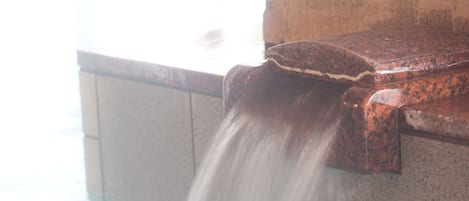 A water feature with a concrete structure and a flowing stream.