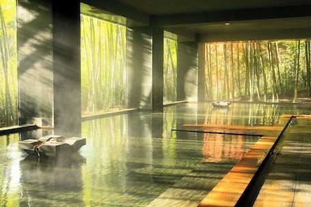 A serene indoor pool with clear reflections, large windows, and a calm atmosphere.