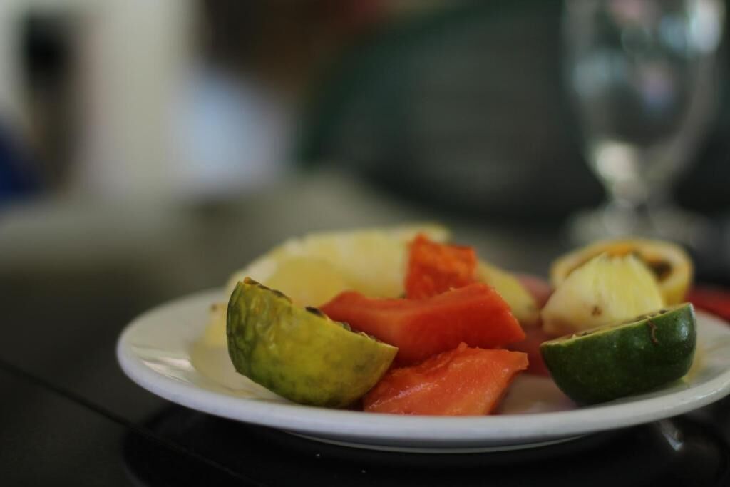 A plate of sliced fruits and vegetables on a table.
