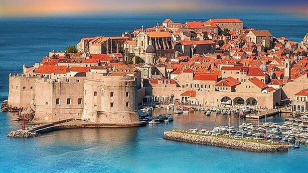 A coastal cityscape with historic architecture, a prominent fortress, and a marina. - Luxury villa with private heated pool and sea view 3 (Marina)